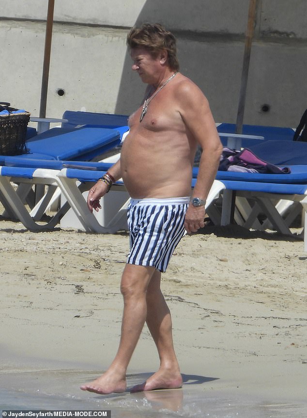 Wilkins later stripped down to a pair of black-and-white striped boardies for a swim