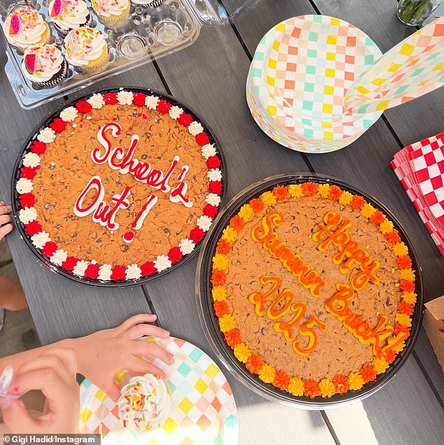 The little girl eagerly dug into a frosted mini-cupcake during a summer break celebration that also included two cookie 'cakes'