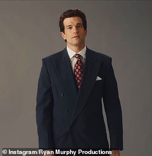 Paul wore a double-breasted, gray suit which was paired with a white dress shirt and red-patterned tie