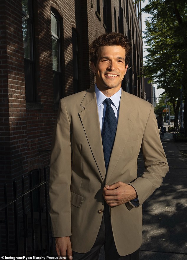 Kelly flashed a smile wearing a tan suit jacket which was paired with dark trousers as well as a pale blue dress shirt