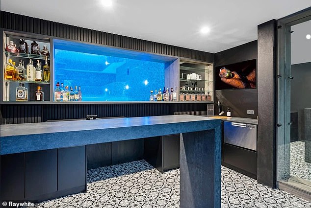 Among the highlights is a sunken bar, which features a 'window' beneath the property's huge pool