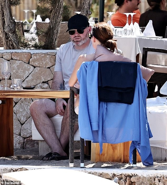 Former Manchester United and England footballer Wayne, also 39, looked every bit the holidaymaker as he reclined on a sun lounger with a glass of sparkling Sangria in hand