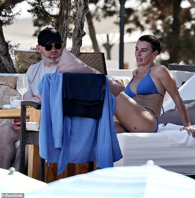 Coleen turned heads in a striking blue halter neck bikini, showing off her enviable figure as she cooled off with a swim before going join Wayne for a drink at the club