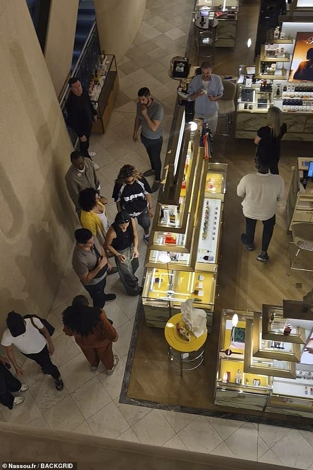 Adding to her cool off-duty look, Blue shielded her eyes with chic black sunglasses and appeared in great spirits as she sampled perfumes inside the luxury department store