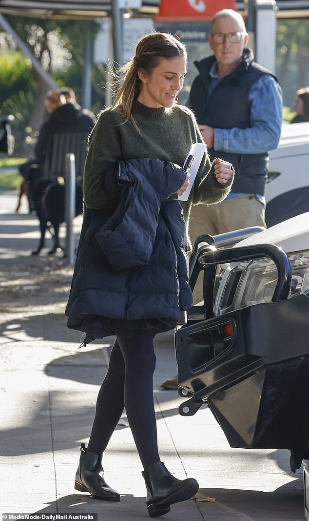 Georgia was rugged up for the occasion, wearing a thick jumper and grey skirt over opaque black stockings