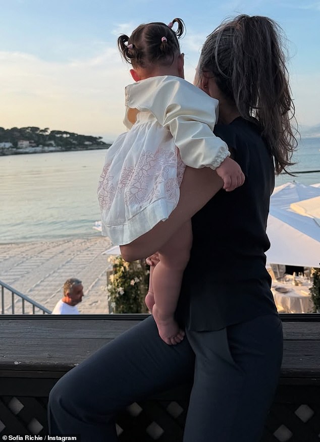 She also uploaded a picture of herself cradling little Eloise as they both stared out an open window to gaze at the dazzling ocean view