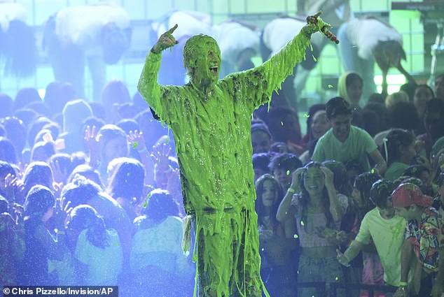 At the end of his performance, the rapper was covered with green smile and the star tossed his arms into the air seconds afterwards