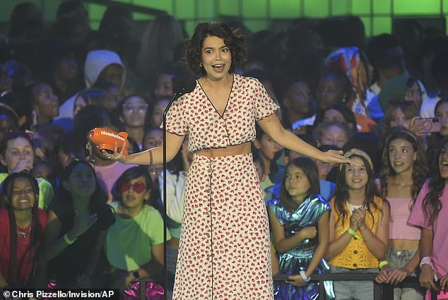 The star jumped to the stage to accept the honor and talked to the audience while holding her orange blimp award