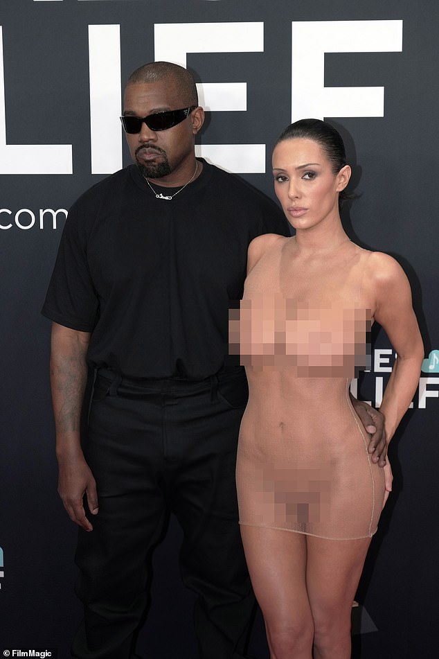 Last month, Censori angered locals after baring her breasts in a sheer bra during a shopping trip with West in Spain (pictured with Kanye in February)