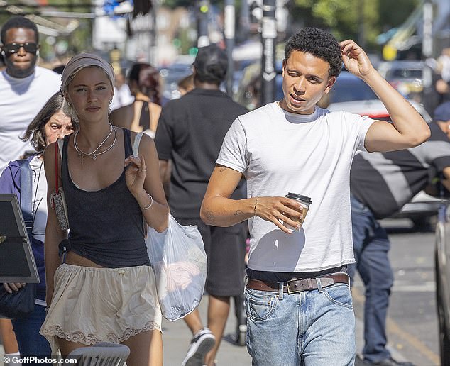 Iris paired the casual ensemble with a pair of cream low-rise satin lace shorts as she stepped out with Tommy
