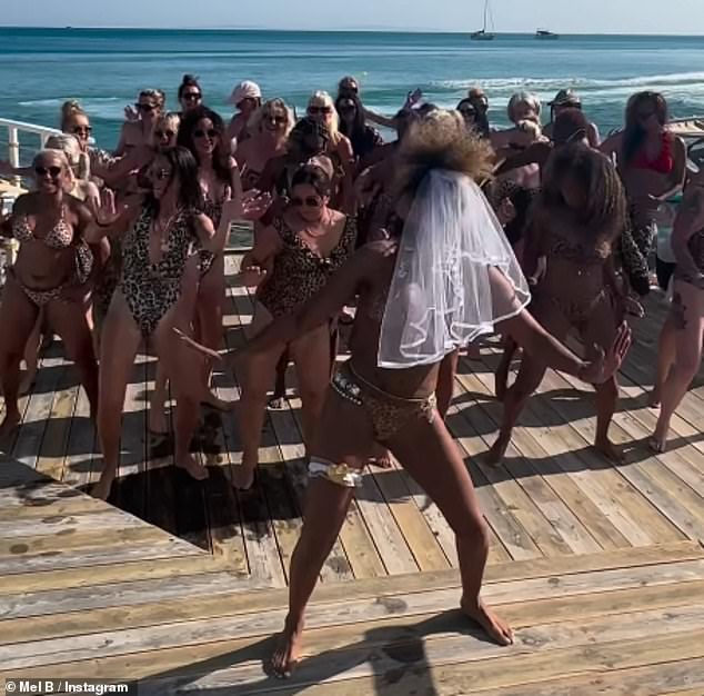 Mel teamed her triangular top and thong with a wedding veil and garter, as well as white lace kimono that she removed to strut her stuff with her pals