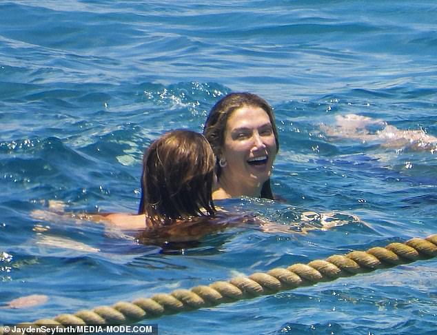 The Aussie popstar couldn't wipe the joy off her face, laughing once in the water