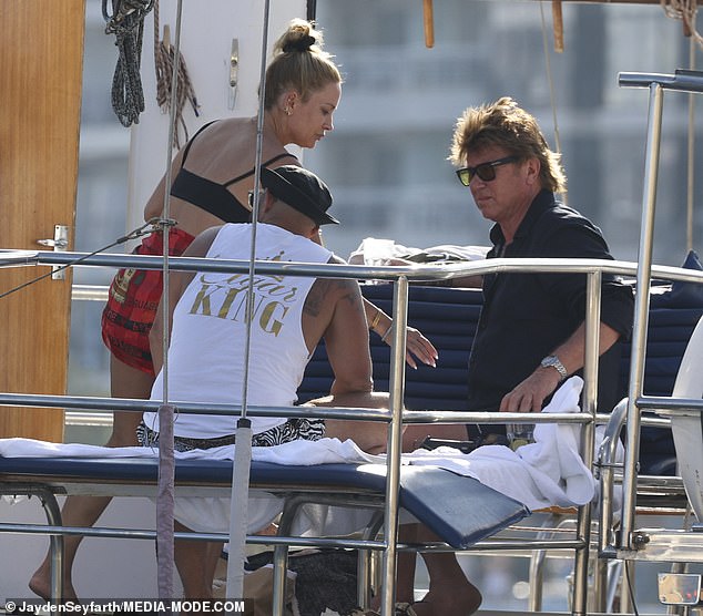 Richard was seen sitting chatting to a male friend, before deciding to also take a dip in the water