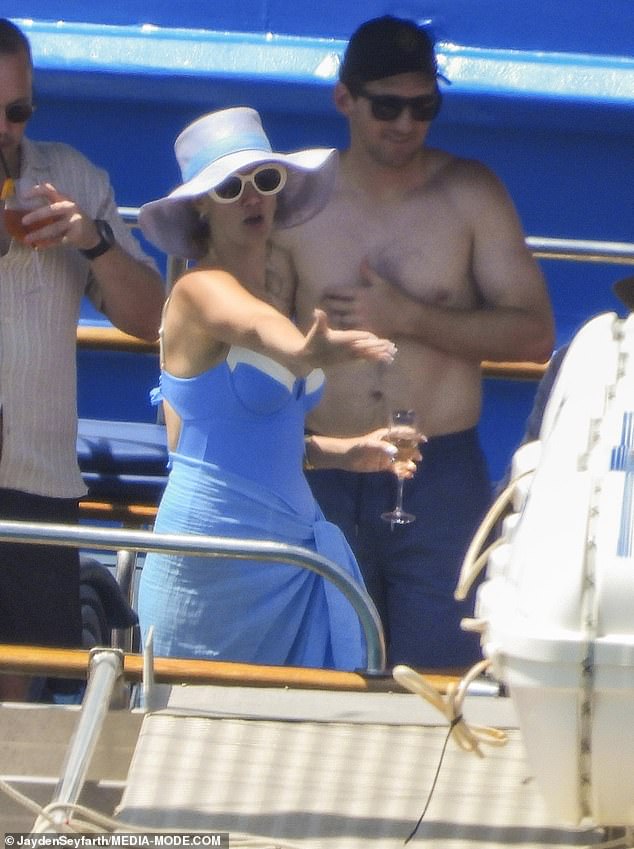 Delta appeared to be in a fun, loving mood, inviting her guests to dance on the boat