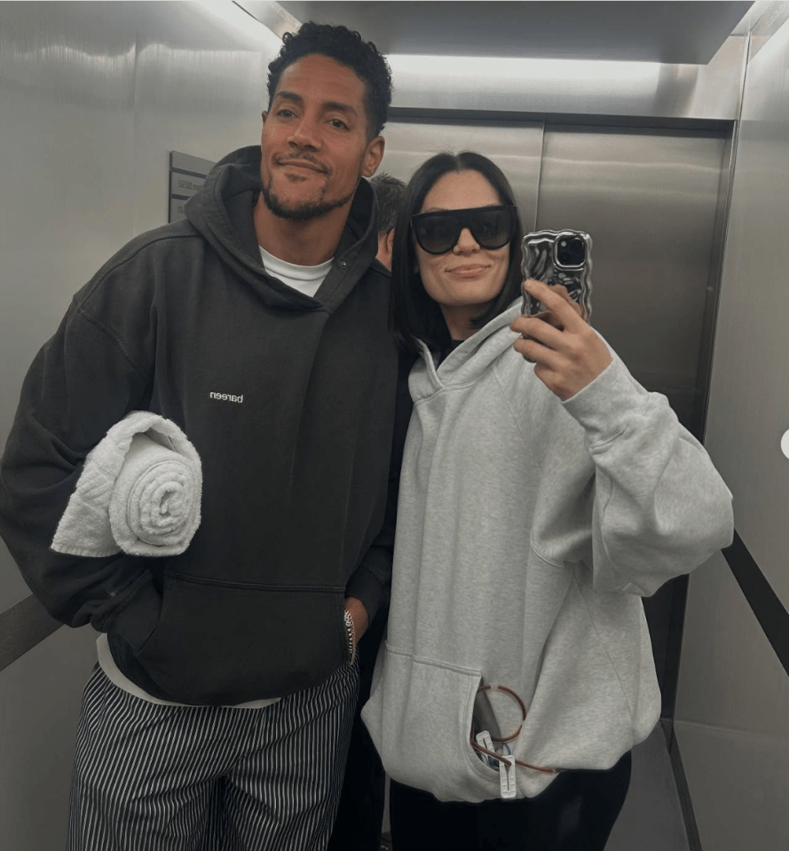 Couple in hoodies in an elevator selfie.