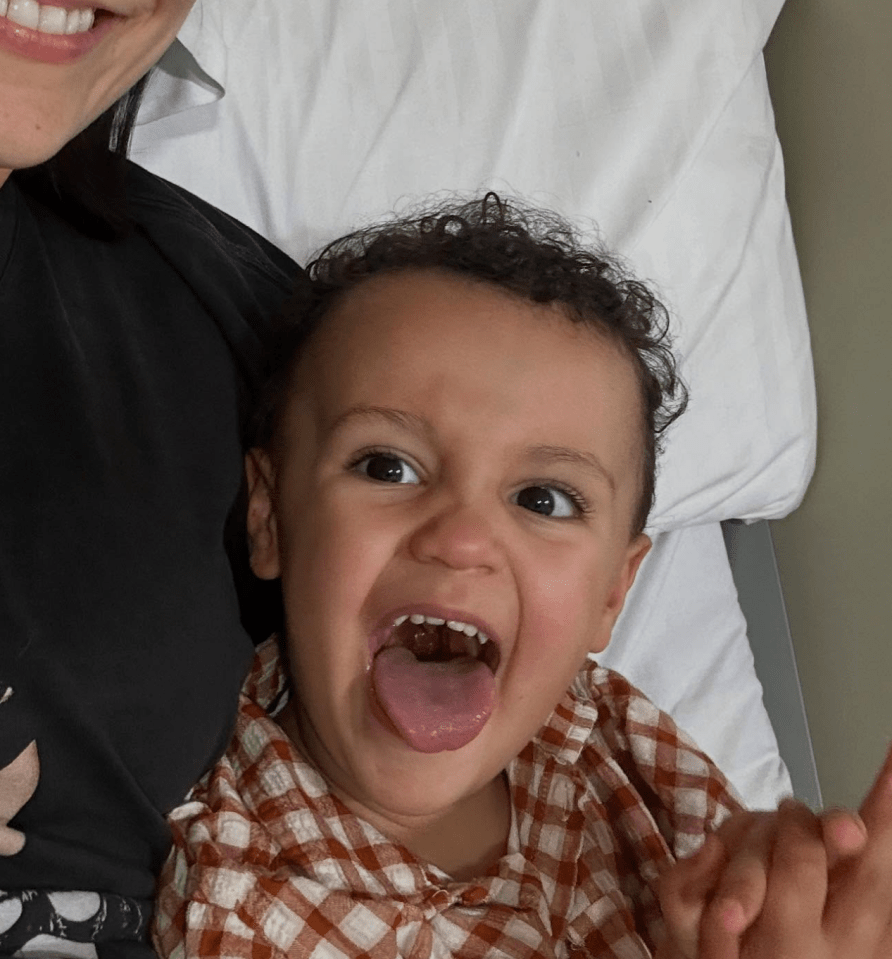 Toddler sticking out tongue.