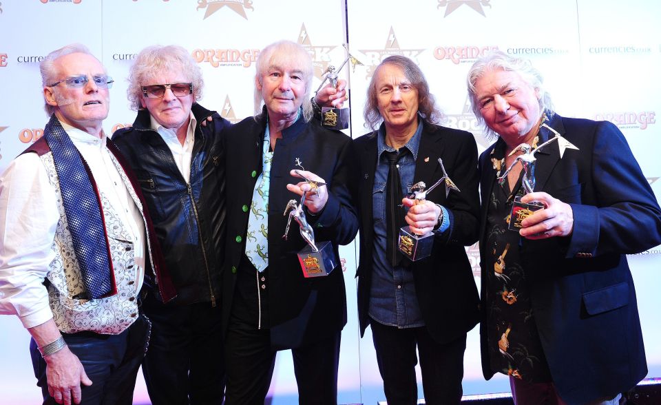 Mott The Hoople band members accepting an award.