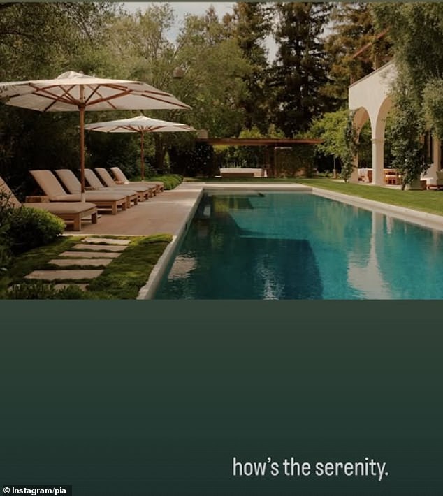 The photo showed a luxurious outdoor living space complete with a pool and several umbrella covered lounge chairs
