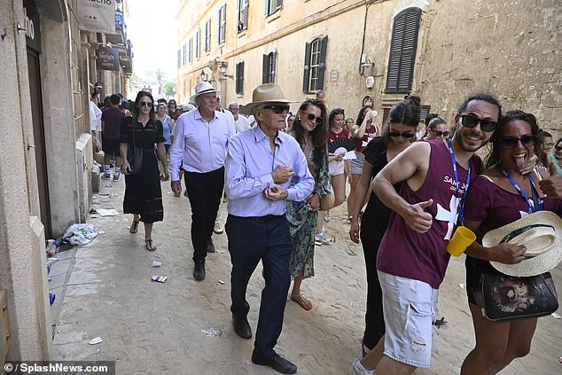 Michael, who was also sporting a pair of stylish dark sunglasses, proudly walked beside his daughter through the streets of Ciudadela
