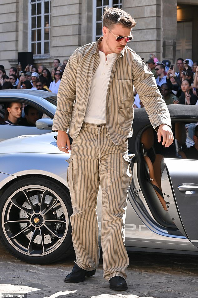 The British actor, 32, looked cool in the smart jacket which he layered over a white waffle polo shirt and matching cargo trousers