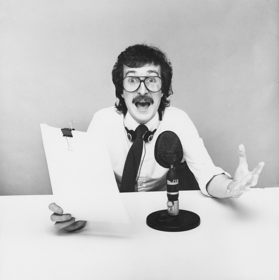 Black and white photo of Steve Wright, a BBC Radio 1 DJ, at a microphone.