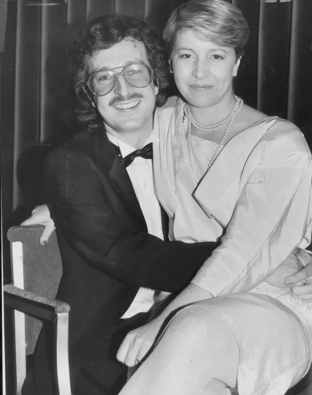 Black and white photo of a couple sitting together.