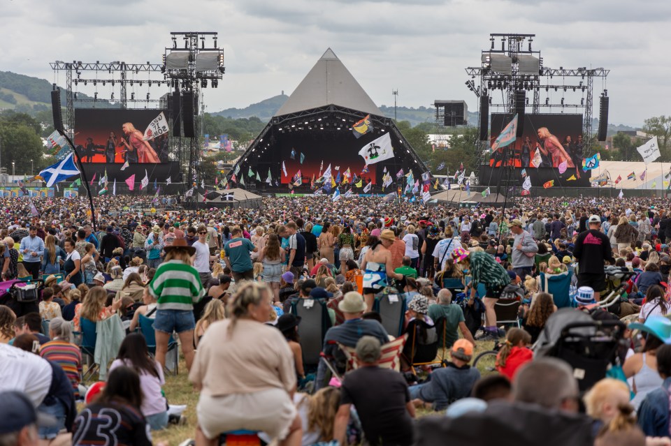 Large crowd at Glastonbury Festival watching a performance on the Pyramid Stage.