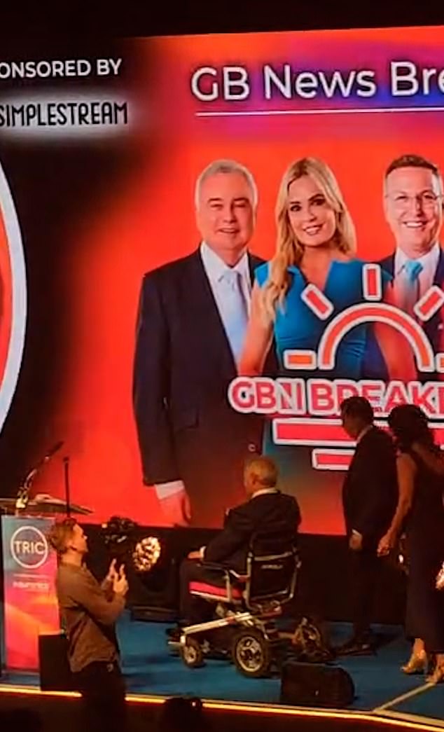 The TV presenter, 65, entered the stage via a wheelchair ramp before he accepted the gong on behalf of the team