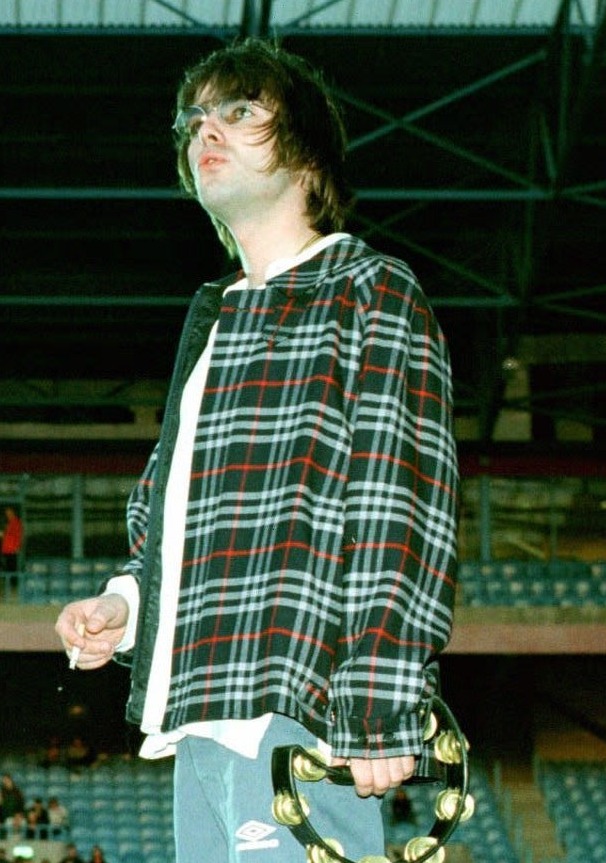 Liam Gallagher holding a tambourine.
