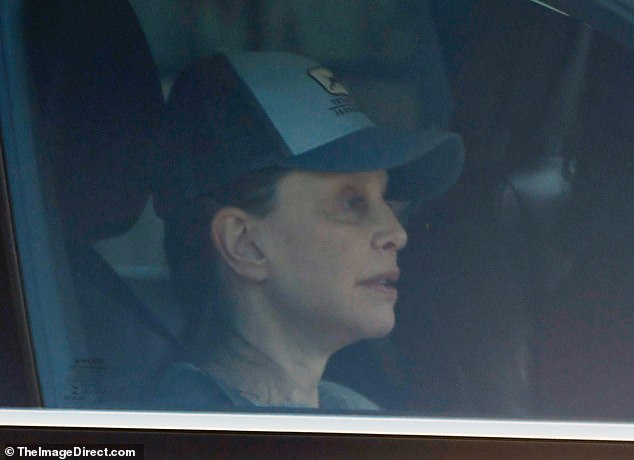 Ally McBeal star Flockhart, 60, who was snapped kissing her husband, 82, on the NYC subway in April, went make-up free and donned a trucker cap as she headed out in LA