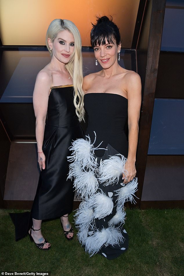 She was also joined by pal Lily, 40, who turned heads in a strapless black gown adorned with dramatic white feathers and polka dots