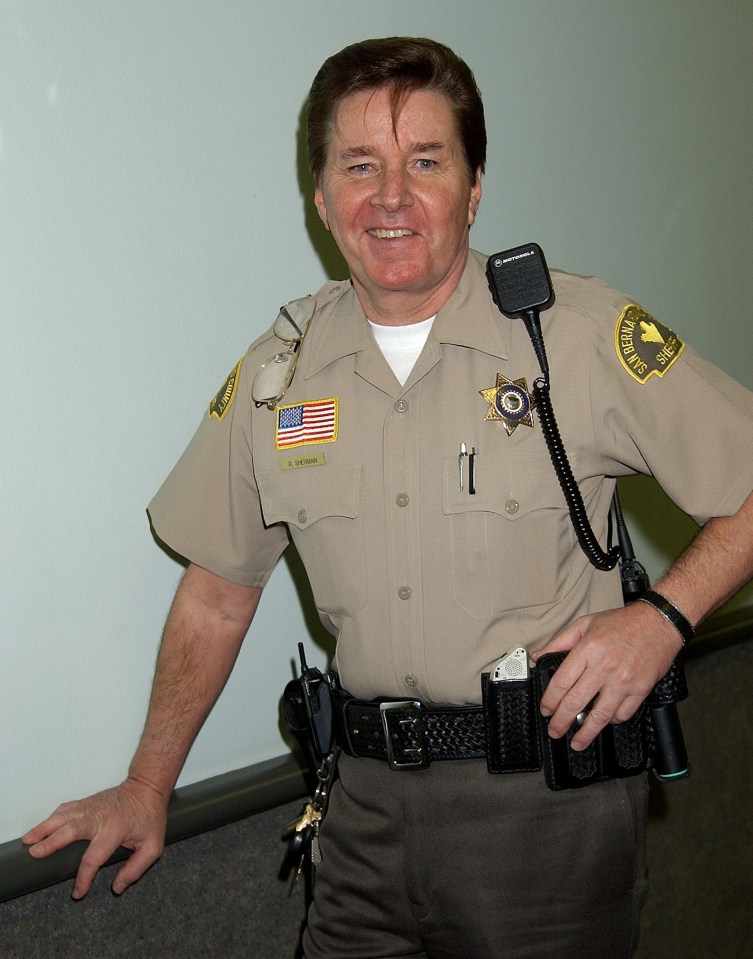 Portrait of a smiling San Bernardino County Sheriff in uniform.