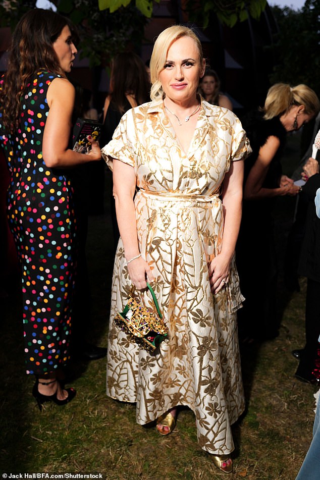 Rebel cut a stylish figure in her eye-catching shirt dress as she posed for snaps at the swanky summer party