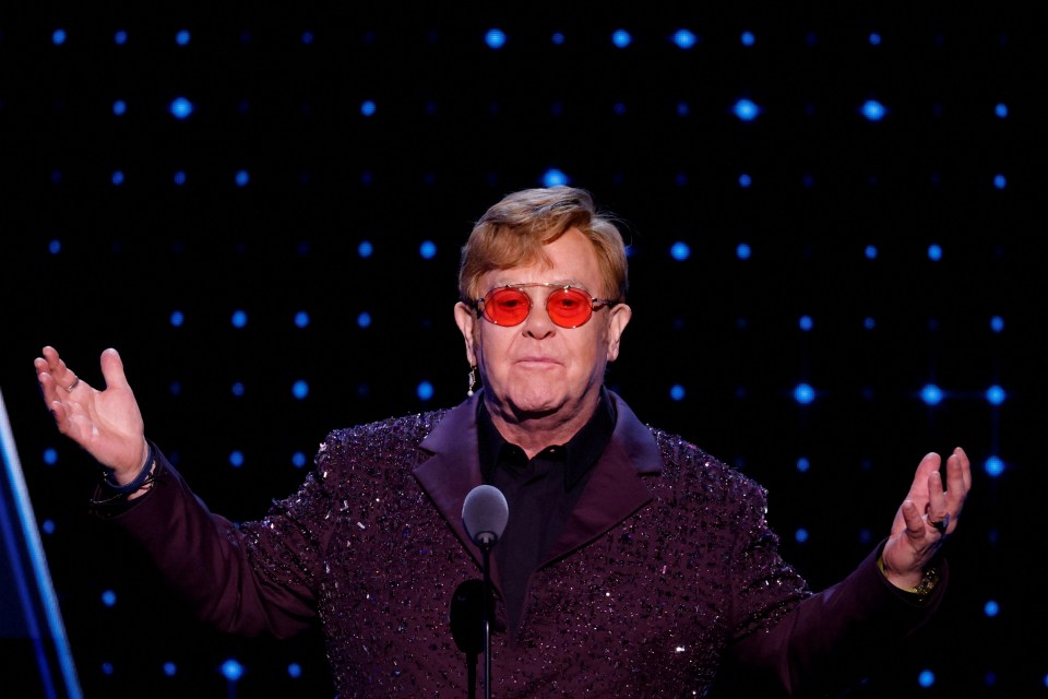 Elton John presenting an award.