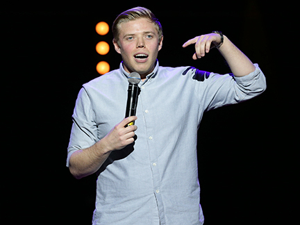 Rob Beckett performing stand-up comedy.