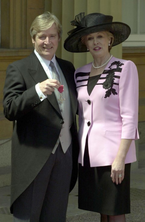 Coronation Street actor William Roache, who plays Ken Barlow in the long running soap, with his wife Sara after he received his Member of the British Empire (MBE) medal from Britain's Queen Elizabeth II at Buckingham Palace in London Tuesday 22 May 2001. See PA story ROYAL Barlow. PA Photo: Matthew Fearn. WPA ROTA