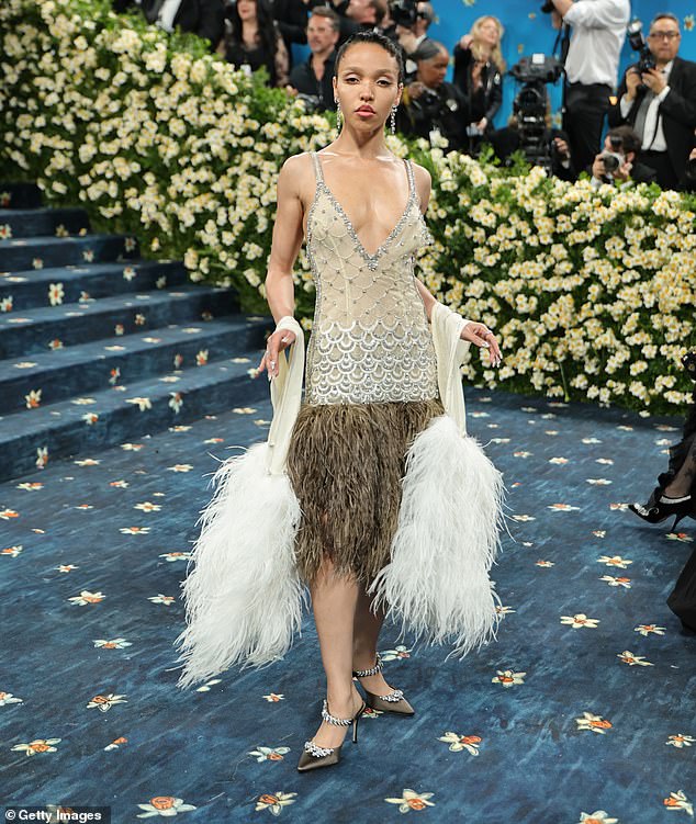 She turned heads as she went braless under the plunging dazzling number as she posed up a storm on the star-studded blue carpet