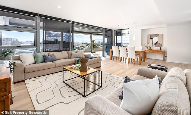 Located on the fifth storey of a prestige block a stone's throw from the harbour, the beautiful flat boasts stunning city views. Pictured: The dining area