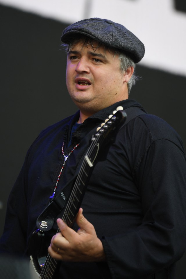 Pete Doherty of The Libertines playing guitar at the Glastonbury Festival.