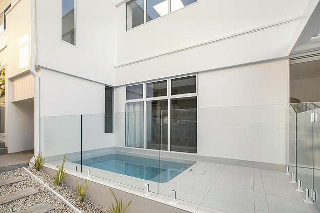 The property boasts five bedrooms, four bathrooms, a double garage, 'expansive open plan', and a rear lawn that features an inground swimming pool