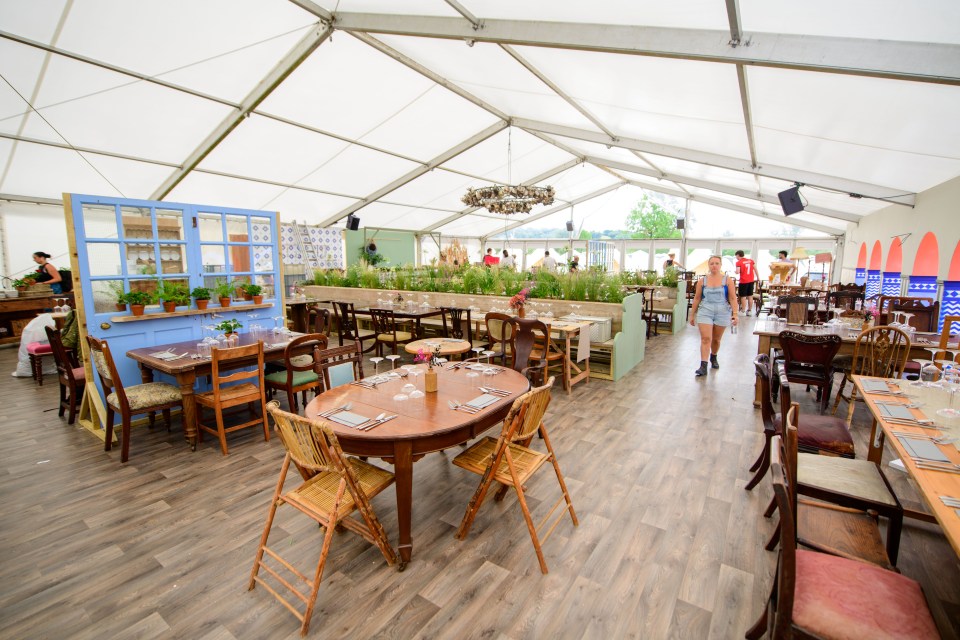 Interior of a restaurant in a tent at a festival.