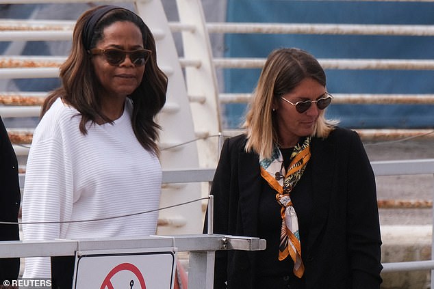 Oprah kept things casual in a ribbed white jumper as she made her way to her hotel