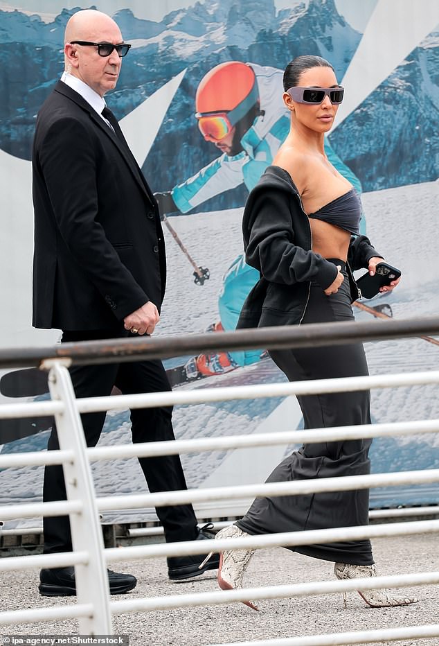 Kim was flanked by security as she left the airport and headed to greet the wedding couple