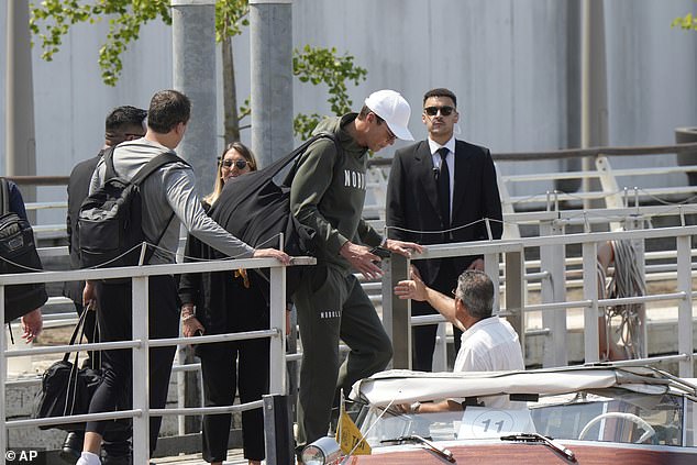 The former NFL quarterback dressed down in a hoodie and baseball cap as he hopped on board a waiting boat