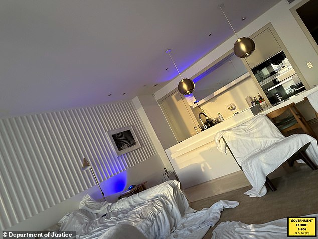 A photo of a what appears to be a hotel room, with towels and blankets strewn across the floor and living area