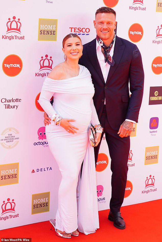 Pregnant Olivia Bowen cradled her baby bump in a white gown as she posed with husband Alex Bowen