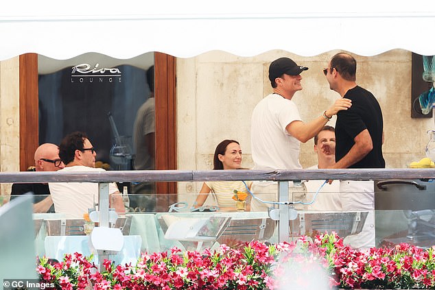 Kim ensured she would turn heads as she arrived at her Venice hotel in a tiny ab-flashing bandeau top on Thursday