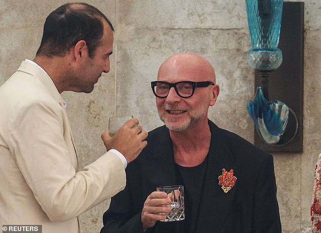 Fashion designer Domenico Dolce enjoys a laugh and a drink at Gritti Palace Hotel earlier today