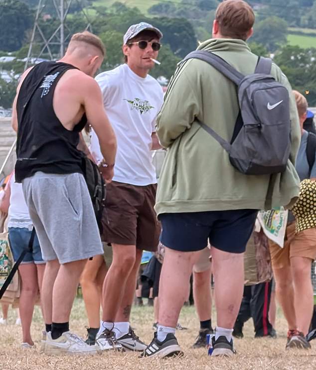 He was seen lighting a cigarette as he mingled with fellow festival-goers ahead of what is expected to be a busy three days at Glastonbury