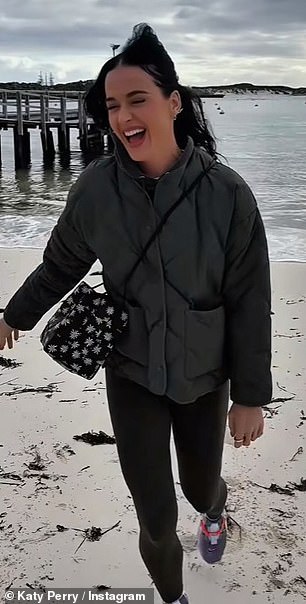 Katy seemed in great spirits on the trip as she posted videos running along the beacha